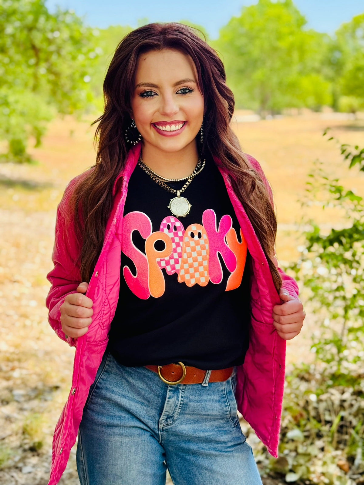 Gold glitter "Spooky" text on a black Texas True Threads T-shirt, featuring a fun Halloween-themed design.