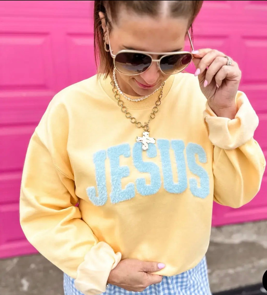 Jesus fluffy patch on yellow haze sweatshirt from Al + Gray Graphic Tees, showing detailed patch design on soft yellow sweatshirt.