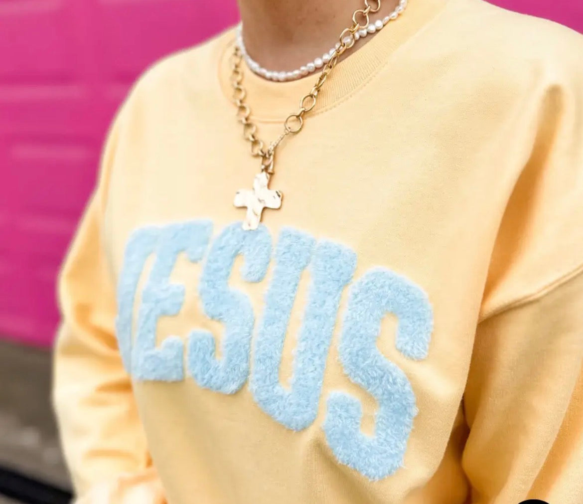 Jesus fluffy patch on yellow haze sweatshirt from Al + Gray Graphic Tees, featuring a soft embroidered Jesus design.