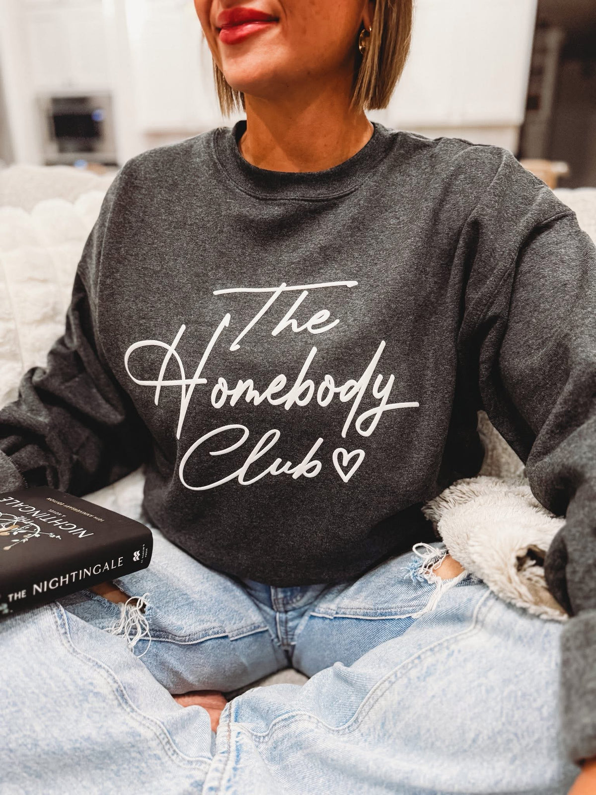 Small Al + Gray Graphic Tees The Homebody Club t-shirt with a bold logo print on the front.