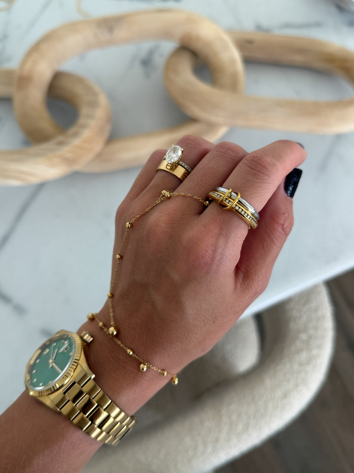 Elegant gold GLAM ring by Chansuttpearls featuring a sparkling central gemstone and intricate band design.