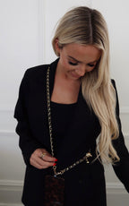 Black phone chain by Chansuttpearls featuring a sleek design and durable clasp, perfect for securing smartphones stylishly.