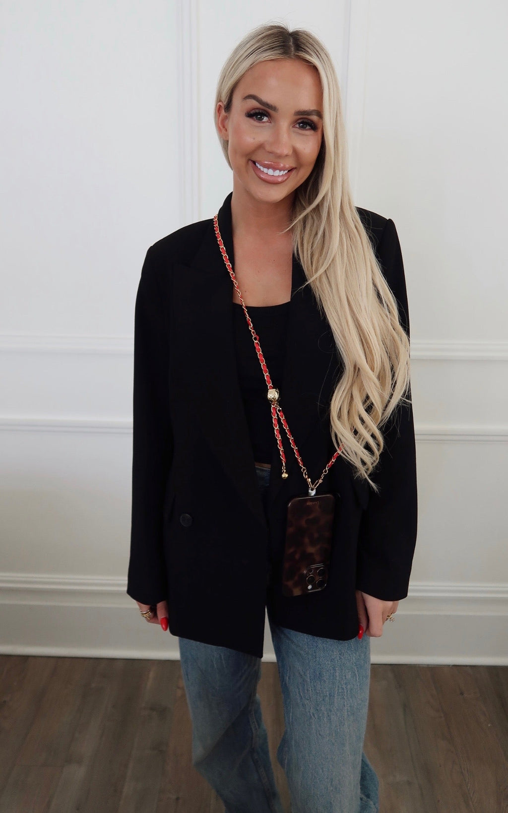 Black phone chain by Chansuttpearls featuring a sleek design and durable links for secure phone carrying.