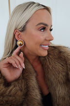 Chansuttpearls Clara earrings featuring elegant pearl accents and gold-tone hooks on a white background.