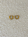Gold Huggies earrings by Chansuttpearls featuring small, shiny gold hoops with a smooth finish.