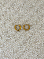 Gold Huggies earrings by Chansuttpearls featuring small, shiny gold hoops with a smooth finish.
