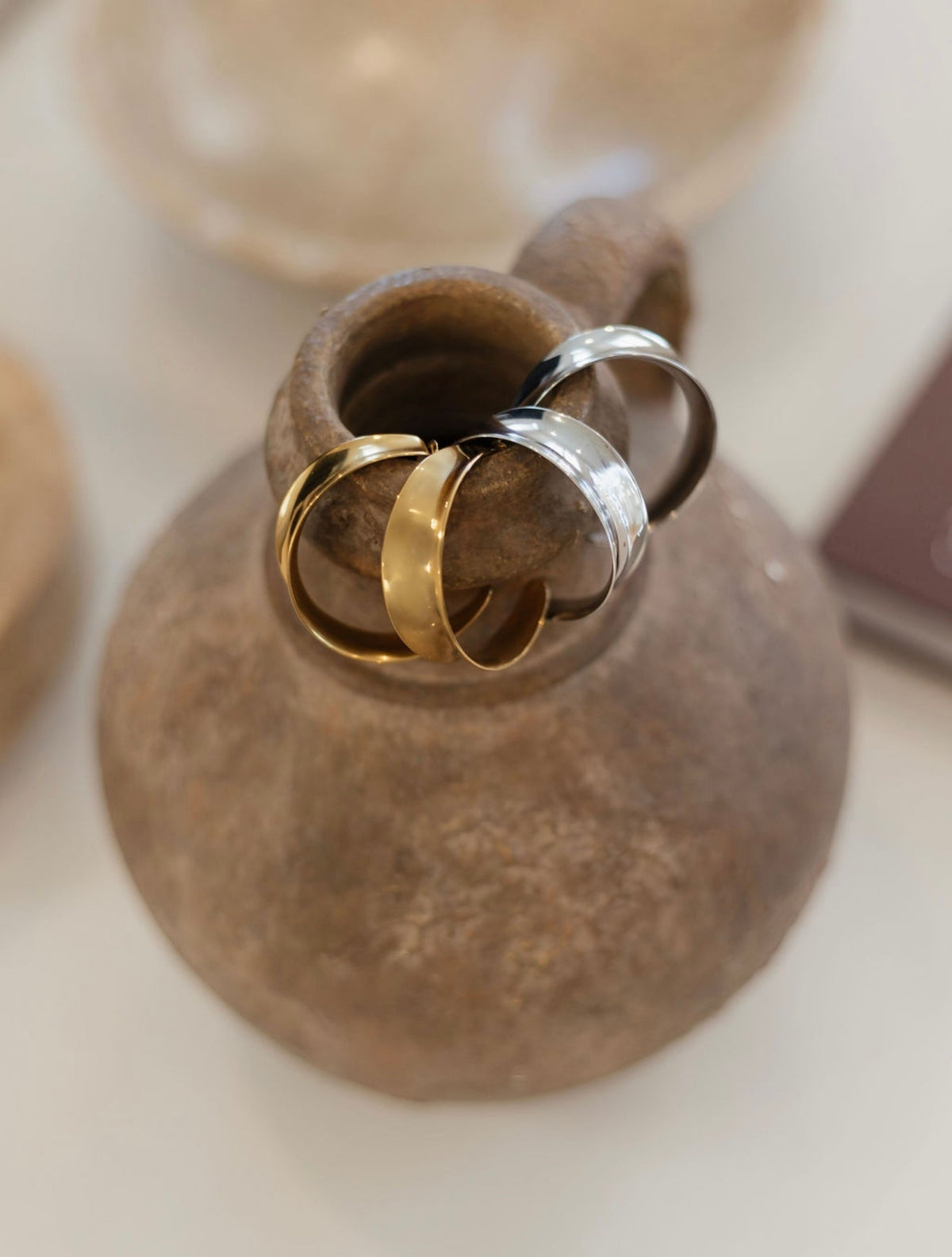 Gold Harlow hoops earrings by Chansuttpearls featuring a sleek, circular design with a polished finish.
