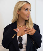 Gold pendant necklace by Chansuttpearls featuring a delicate gold chain and a polished gold pendant.
