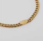 Gold pendant necklace by Chansuttpearls featuring a delicate gold chain and a central gold pendant.