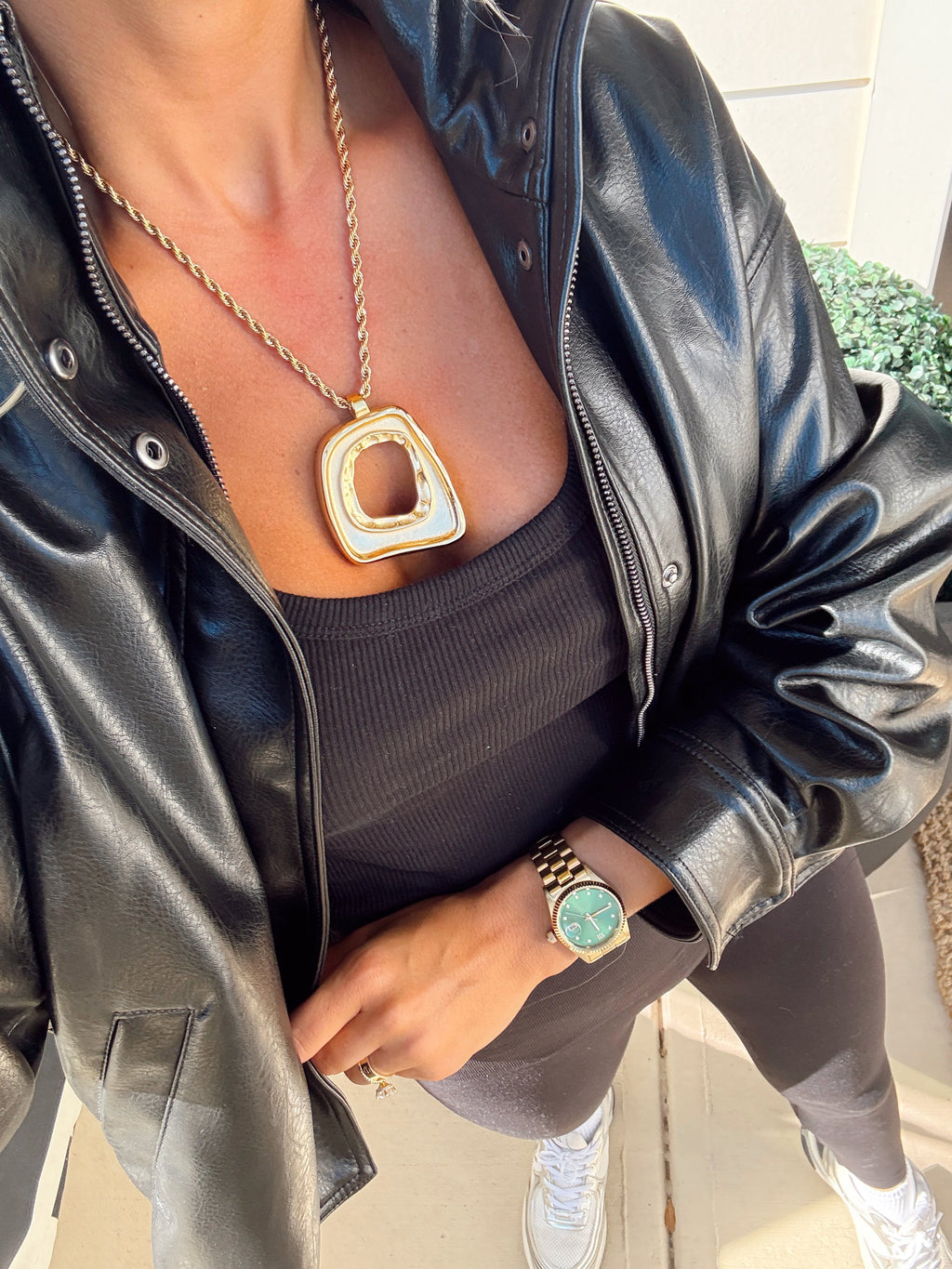 Gold Taylor necklace by Chansuttpearls featuring a delicate chain with a pendant, shown against a neutral background.