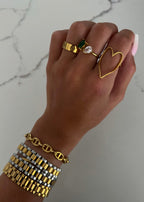 Gold heart ring from Chansuttpearls featuring a shiny gold band and a prominent heart-shaped design.