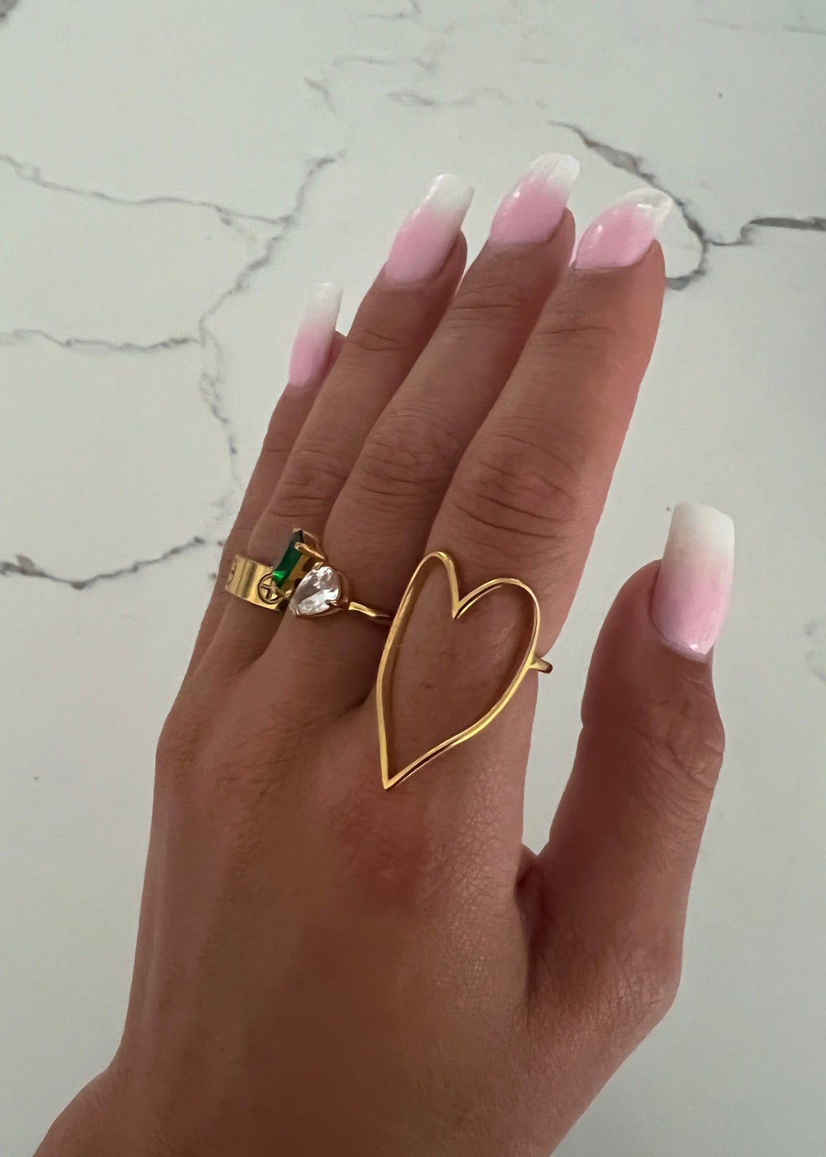 Gold heart ring by Chansuttpearls featuring a delicate gold band and a prominent heart-shaped design.