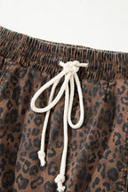 Brown leopard print denim skort with elastic waistband and drawstring, featuring cotton and elastane blend for comfortable fit.