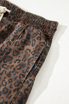 Brown leopard print denim skort with elastic waistband and drawstring, made of cotton and elastane for a comfortable fit.