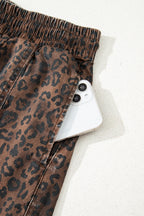Brown leopard print denim skort with elastic waistband and drawstring, featuring a stylish design and comfortable fit.