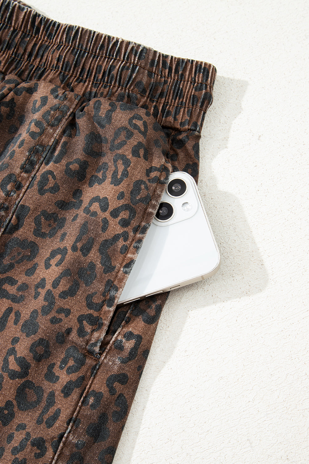 Brown leopard print denim skort with elastic waistband and drawstring, featuring a stylish design and comfortable fit.