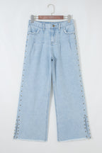 Dear-Lover Blue Wide Leg Jeans with studded side slit, frayed edges, and pocket details, made of cotton and polyester.