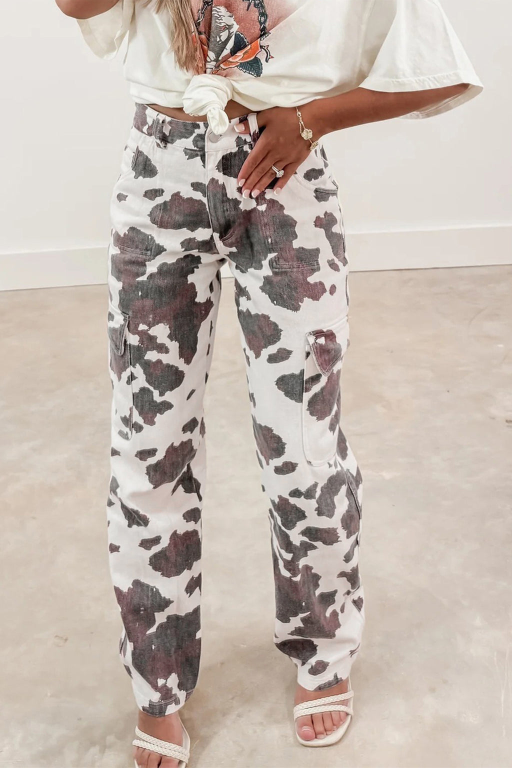 Brown cow spots printed multi-pocketed jeans from Dear-Lover Dropshipping, featuring cotton, polyester, and elastane for a casual look.