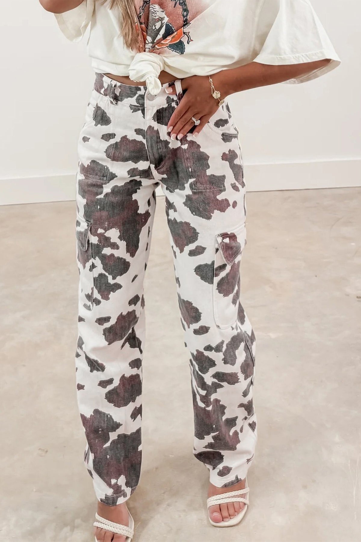 Brown cow spots printed multi-pocketed jeans from Dear-Lover Dropshipping, featuring cotton, polyester, and elastane for a casual look.