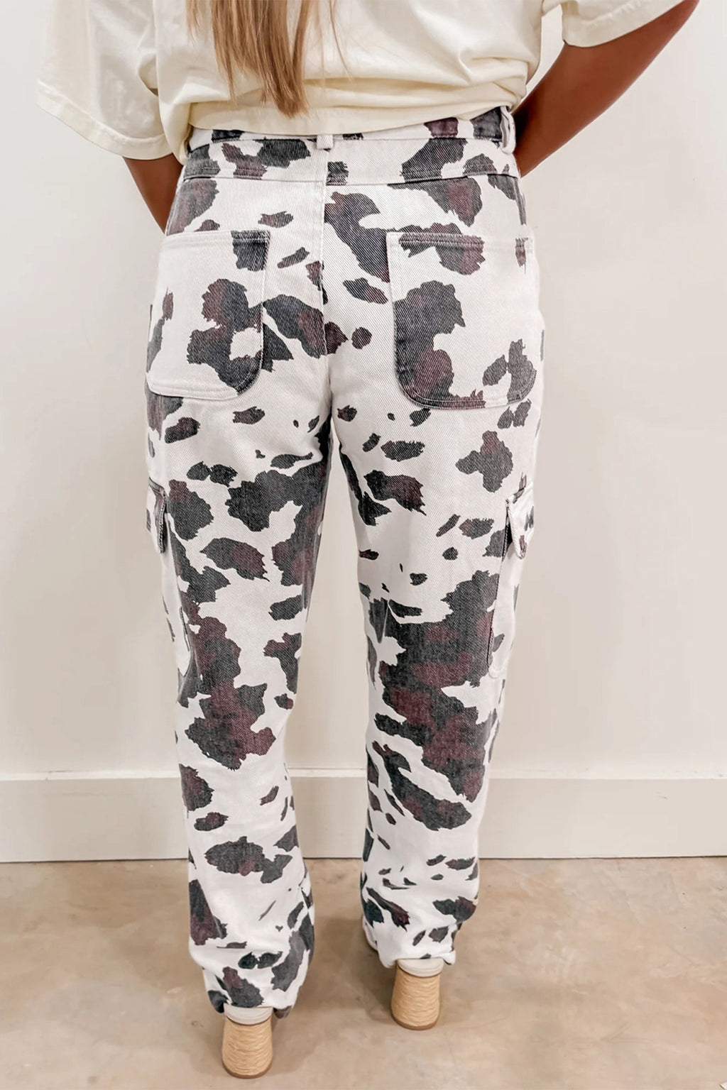 Brown cow spots printed multi-pocketed jeans from Dear-Lover Dropshipping, featuring a stylish, casual design with cotton, polyester, and elastane.