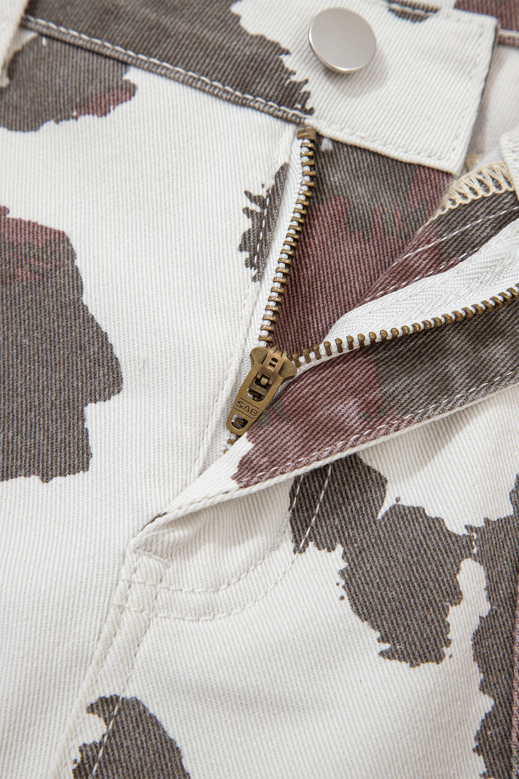 Brown Cow Spots printed jeans with multiple pockets from Dear-Lover, made of cotton, polyester, and elastane for a comfortable fit.