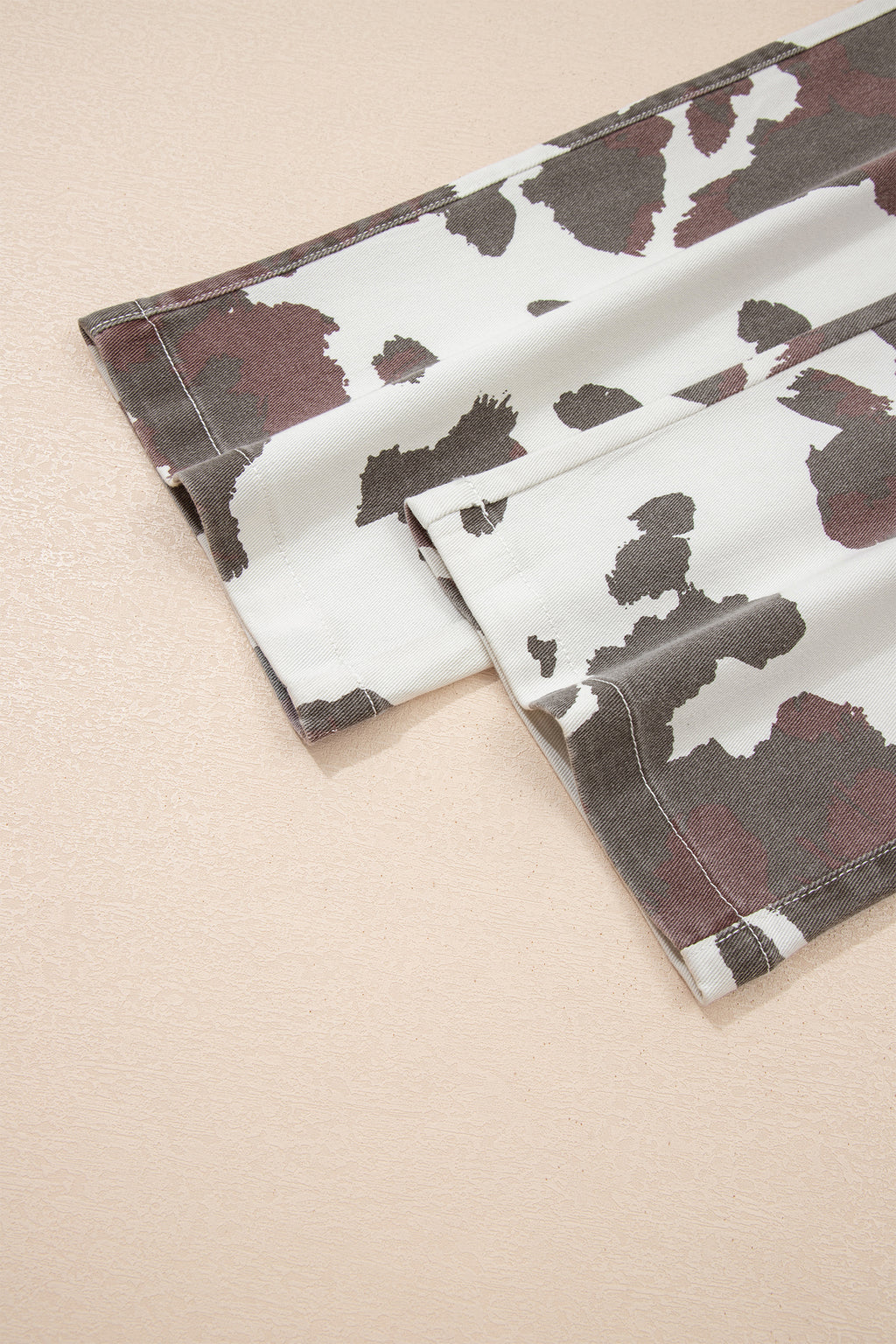 Brown Cow Spots printed multi-pocketed jeans from Dear-Lover Dropshipping, featuring a stylish cow print design and comfortable fit.