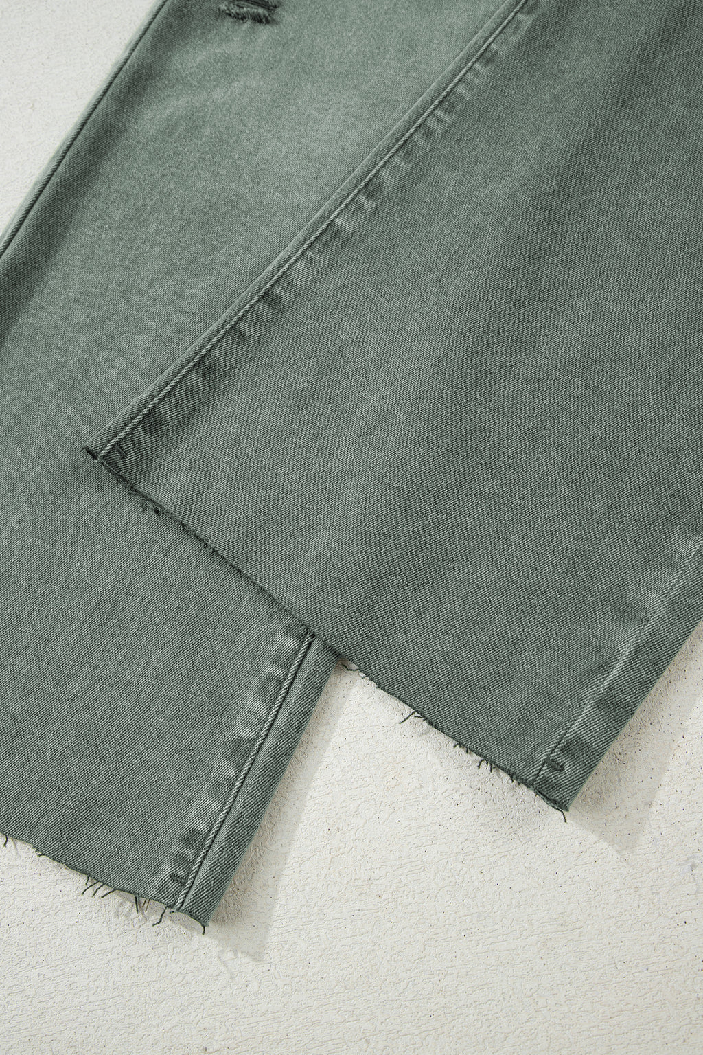 Dear-Lover Four Leaf Clover distressed wide-leg jeans with raw edges, made of cotton and elastane, featuring a subtle four-leaf clover design.