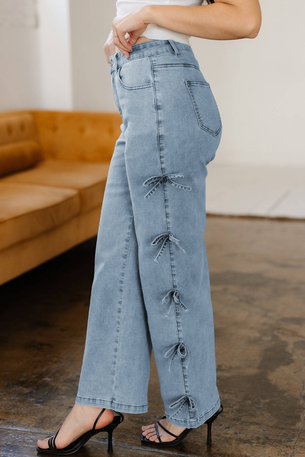White Dear-Lover loose straight-leg jeans with bow knot side detail and cotton-elastane blend, showcasing relaxed fit and casual style.
