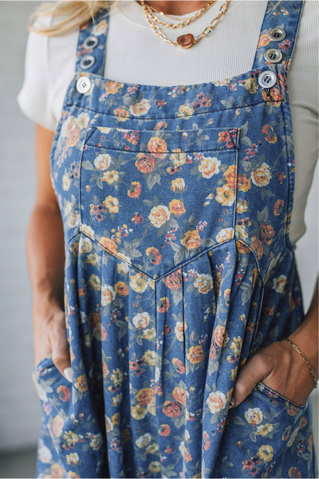 Blue vintage rose printed denim overall jumpsuit with pleated, loose fit, made of cotton, polyester, and viscose fabric.