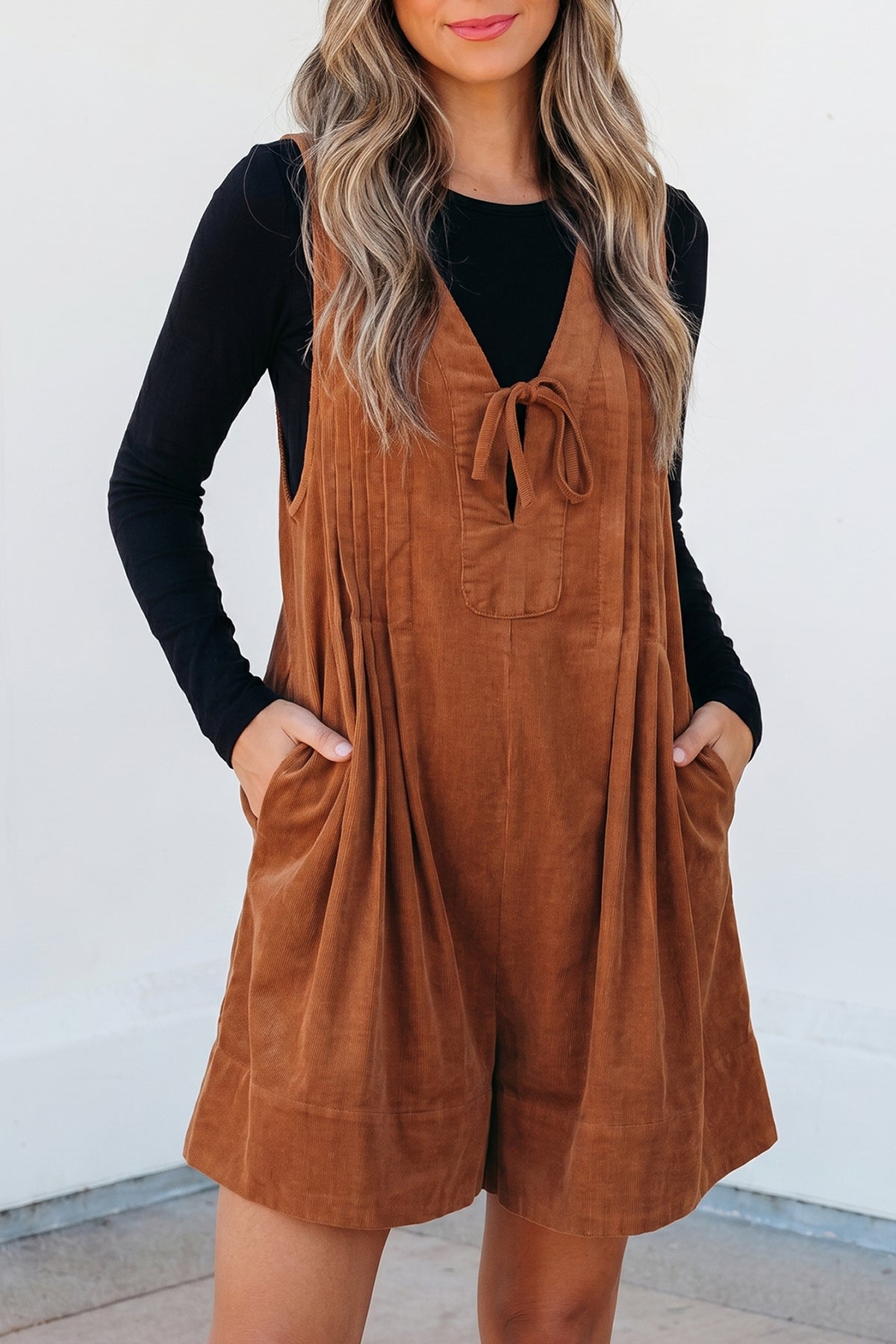 Cinnamon sleeveless corduroy romper with V-neck and tie detail, from Dear-Lover, perfect as a stylish jumpsuit or casual romper.