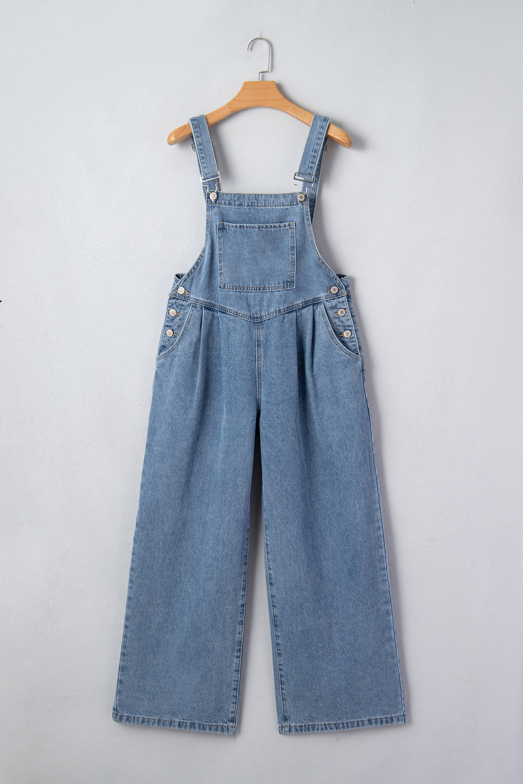 Dusk blue pleated wide-leg denim jumpsuit with retro pockets, featuring a relaxed fit and stylish design.