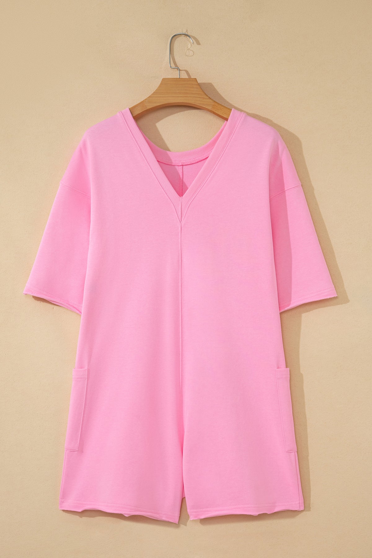 Pink solid color raw edge half sleeve romper with pockets, made of cotton and polyester, loose fit, casual jumpsuit from Dear-Lover.