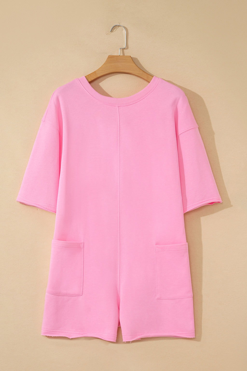 Pink solid color raw edge half sleeve romper with pockets, loose fit, made of cotton-polyester blend, by Dear-Lover.