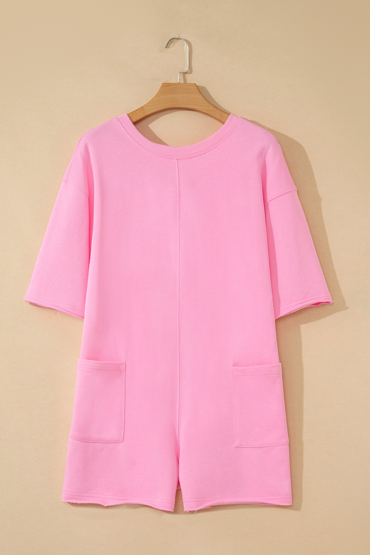 Pink solid color raw edge half sleeve romper with pockets, loose fit, made of cotton-polyester blend, by Dear-Lover.