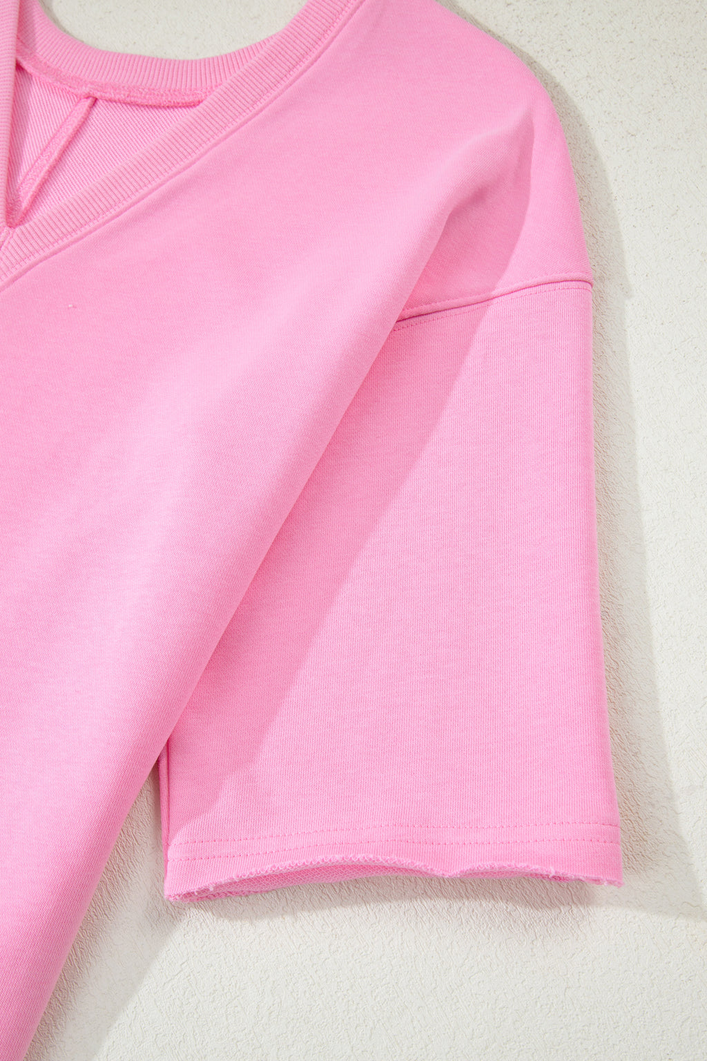 Pink solid color raw edge half sleeve romper with pockets, loose fit, made from cotton and polyester, by Dear-Lover.