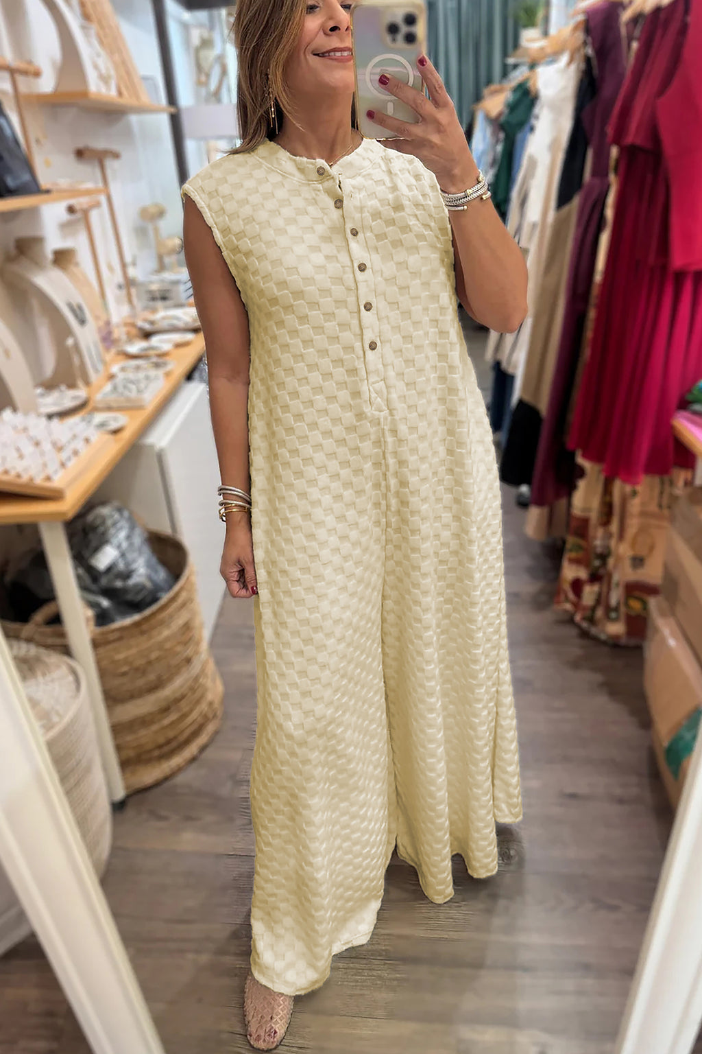 White sleeveless jumpsuit with half buttons, textured fabric, wide-leg design, by Dear-Lover. Perfect for casual or stylish wear.