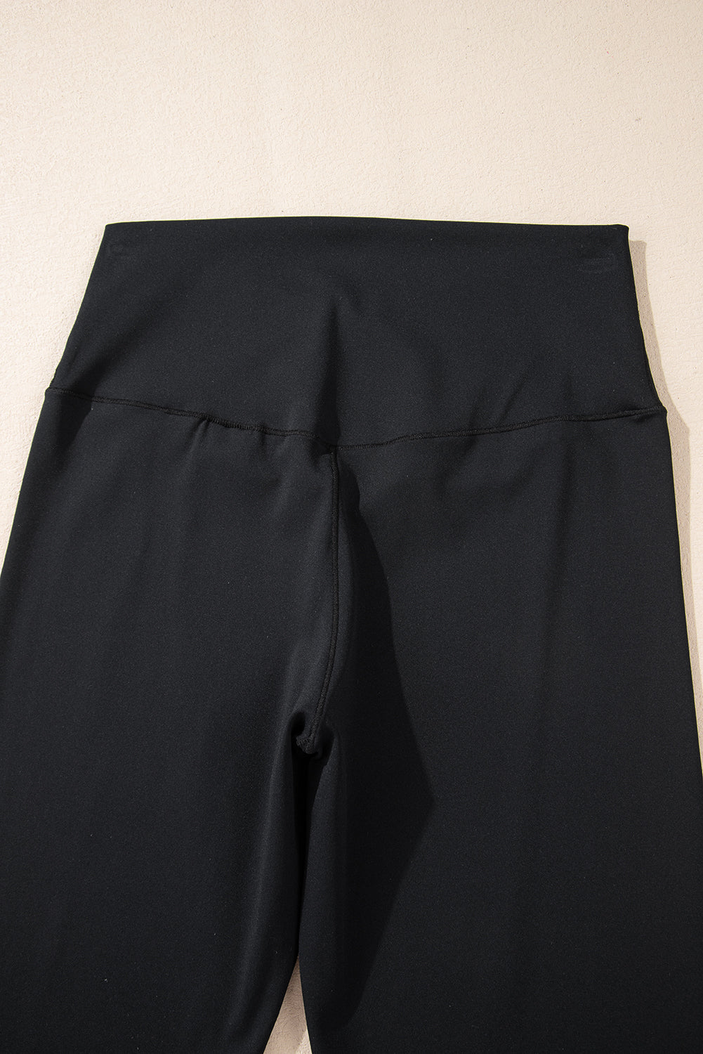 Black V-shape high waist flared leggings by Dear-Lover, made of polyamide and elastane, showing a fitted waist and flared leg design.
