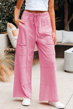 Dear-Lover Bonbon Mineral Wash wide-leg cargo pants with exposed seams, drawstring elastic waistband, and 100% cotton fabric.