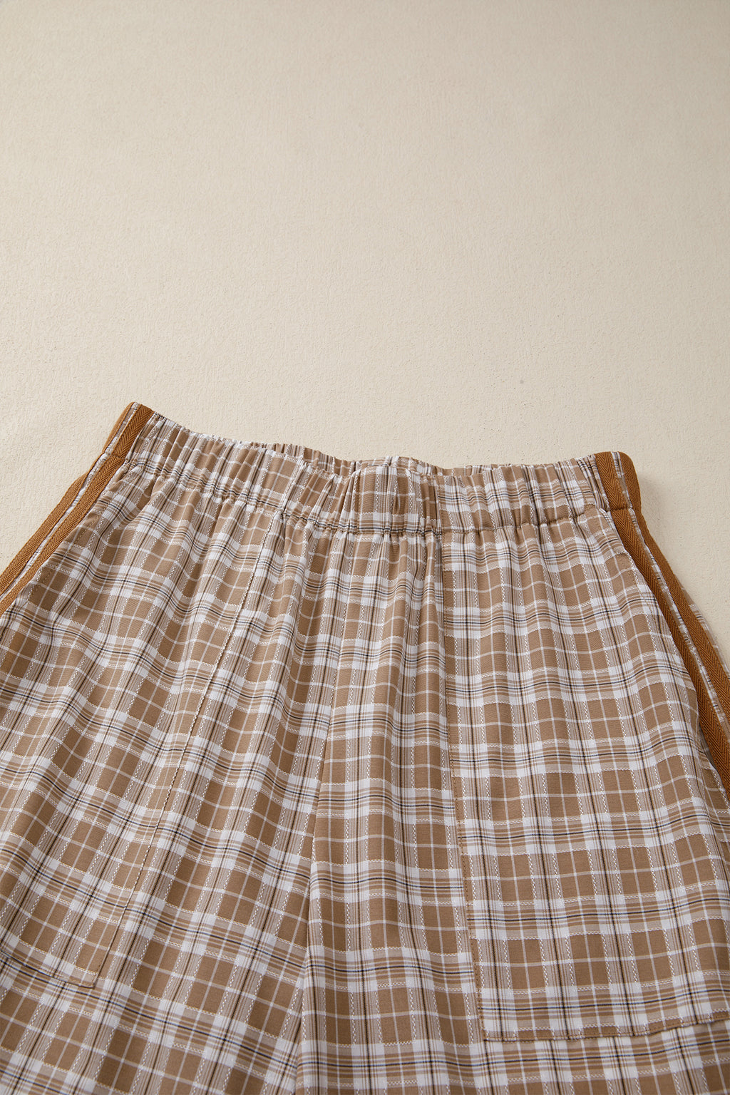 Chestnut plaid print jogger pants by Dear-Lover with elastic waist, bow tie, and contrast details, made of polyester, viscose, and elastane.