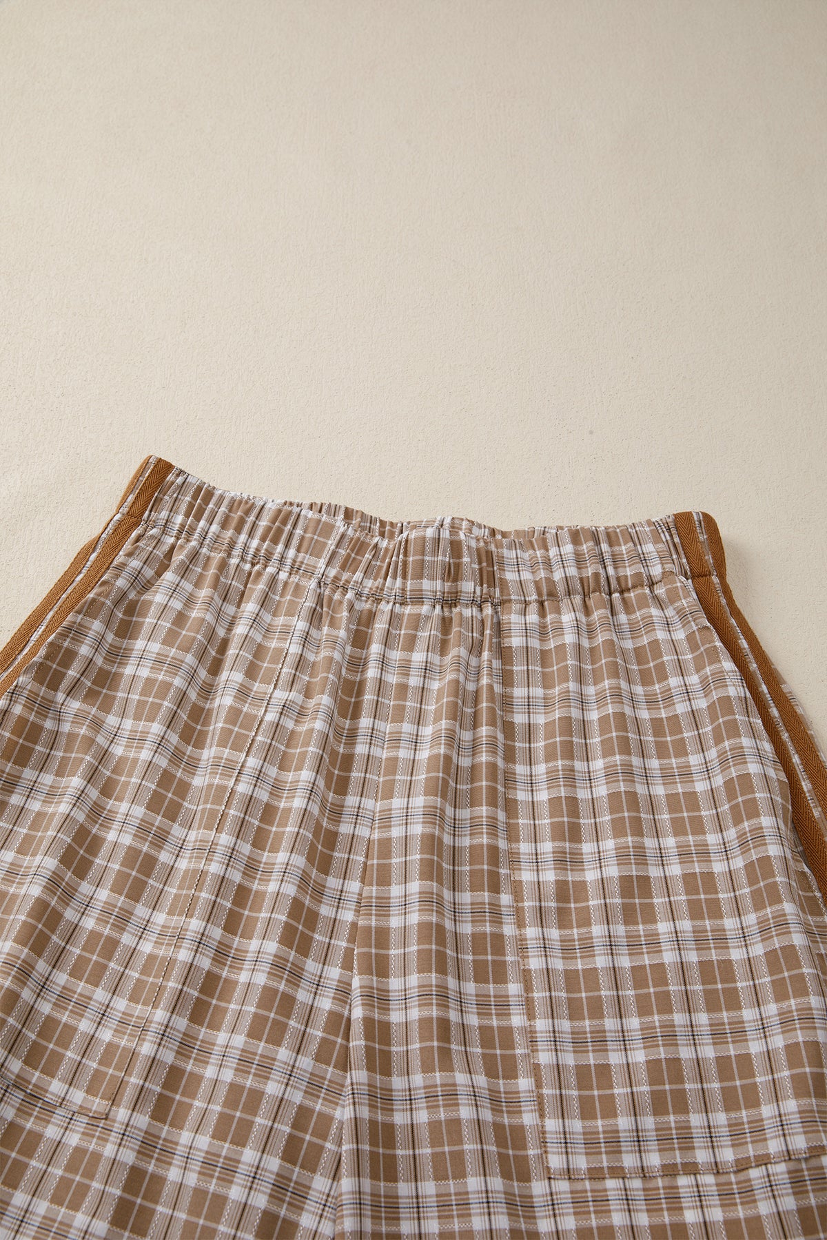 Chestnut plaid print jogger pants by Dear-Lover with elastic waist, bow tie, and contrast details, made of polyester, viscose, and elastane.