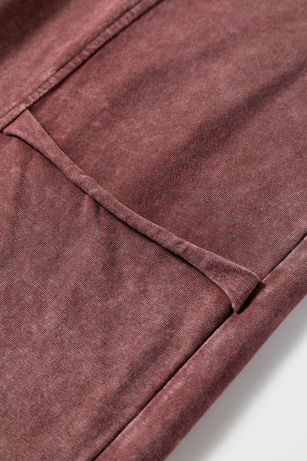 Medium grey high waist lace-up pants with raw hem and patched pockets, made from 100% cotton with a lapis mineral wash.