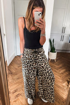 Flowy wide-leg pants by Dear-Lover in parchment leopard print with drawstring elastic waistband and comfortable culotte style.