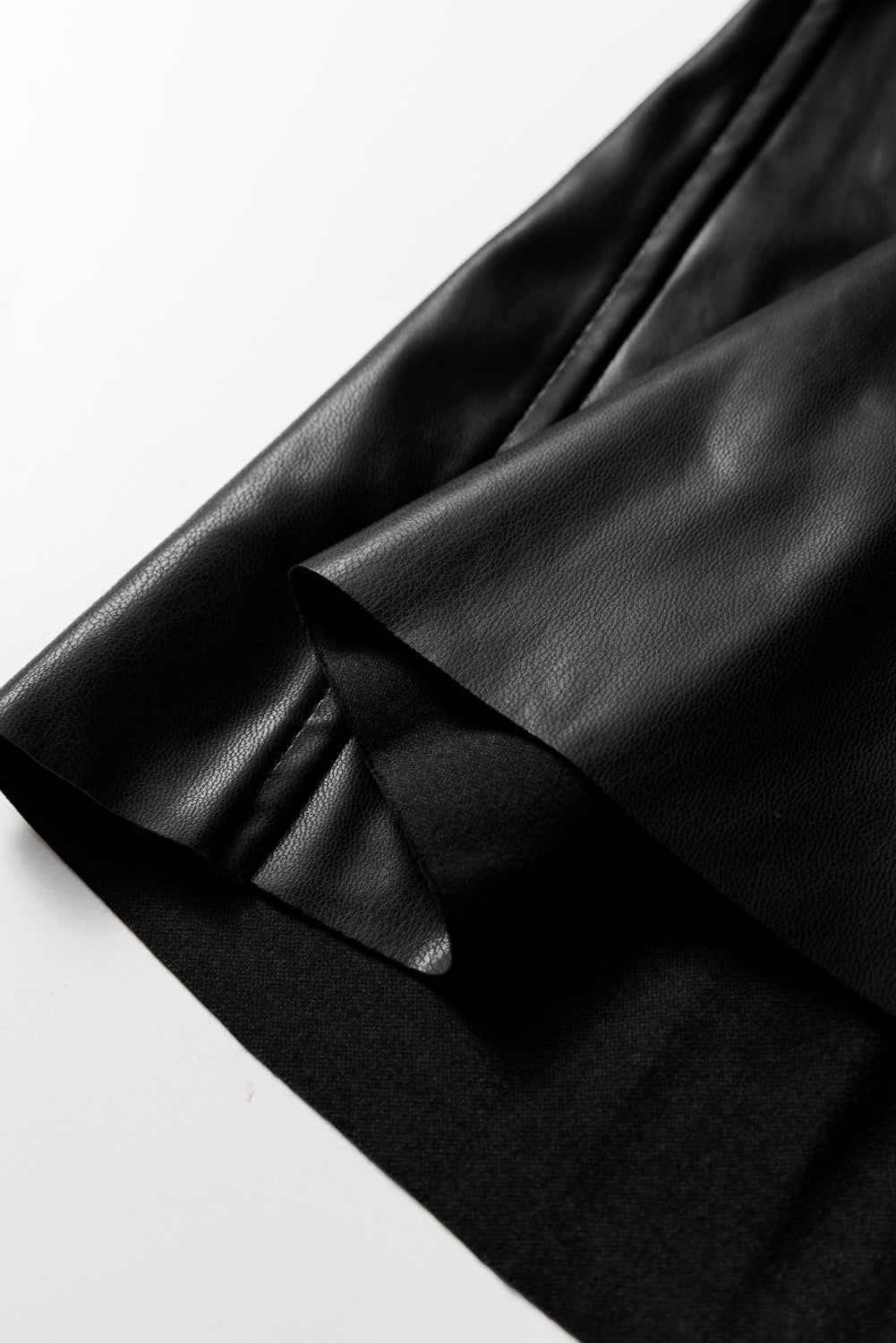 Black faux leather retro buckle detail pleated flared midi skirt by Dear-Lover Dropshipping, showing the stylish skirt with pleats and buckle accents.