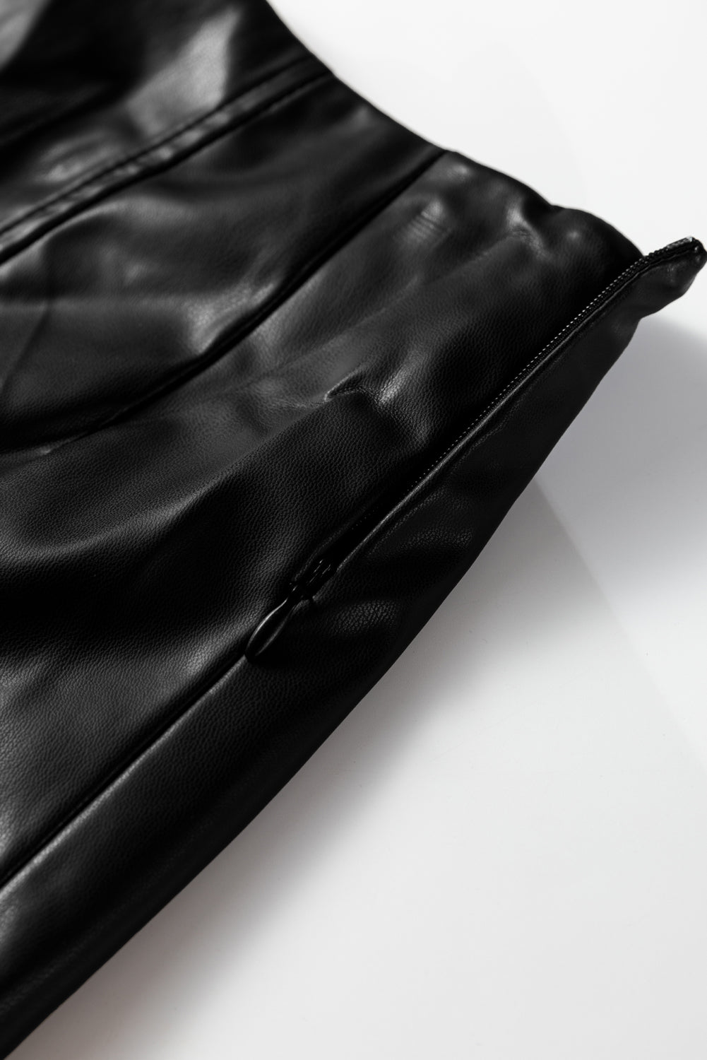 Black faux leather midi skirt with retro buckle detail, pleated stitching, and flared design from Dear-Lover Dropshipping.