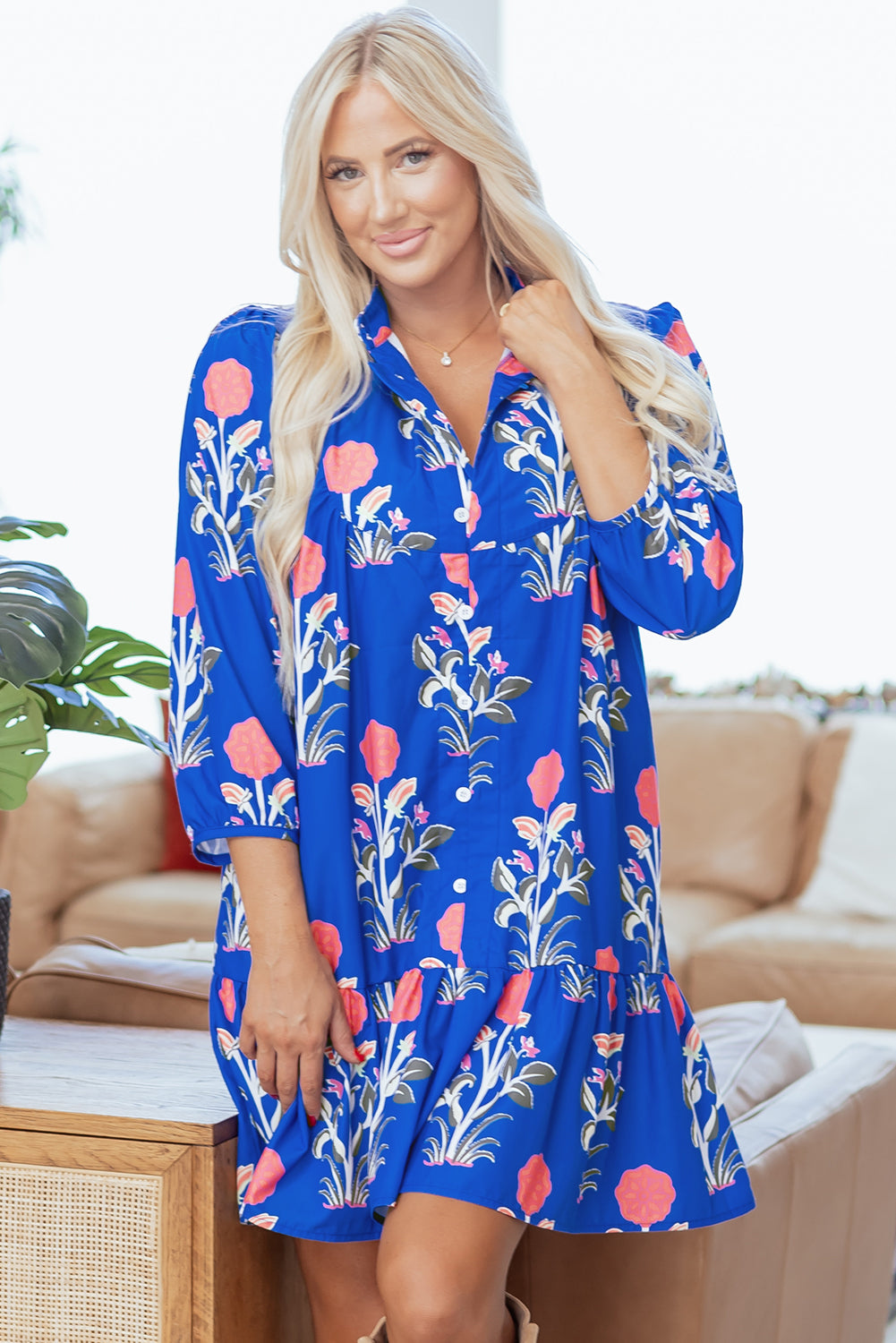 Blue floral print dress by Dear-Lover with button details, 3/4 puff sleeves, and ruffle hem in lightweight polyester fabric.