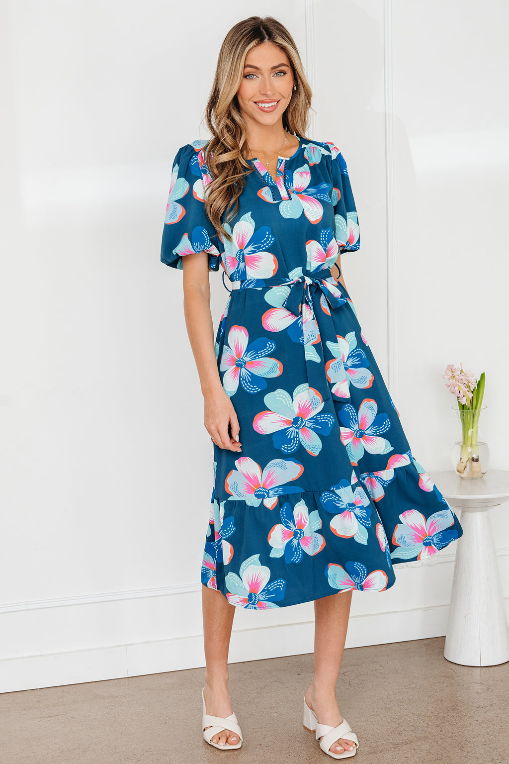 Blue floral print long dress by Dear-Lover with short puff sleeves, ruffle hem, and belt, made of lightweight polyester fabric.