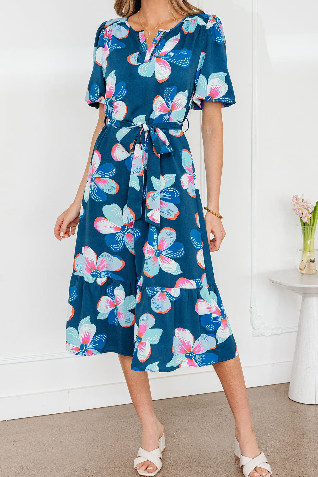 Blue floral print long dress by Dear-Lover with short puff sleeves, ruffle hem, and belt, made of lightweight polyester fabric.