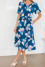 Blue floral print long dress with puff sleeves, ruffle hem, and belt, featuring polyester fabric and elegant design.