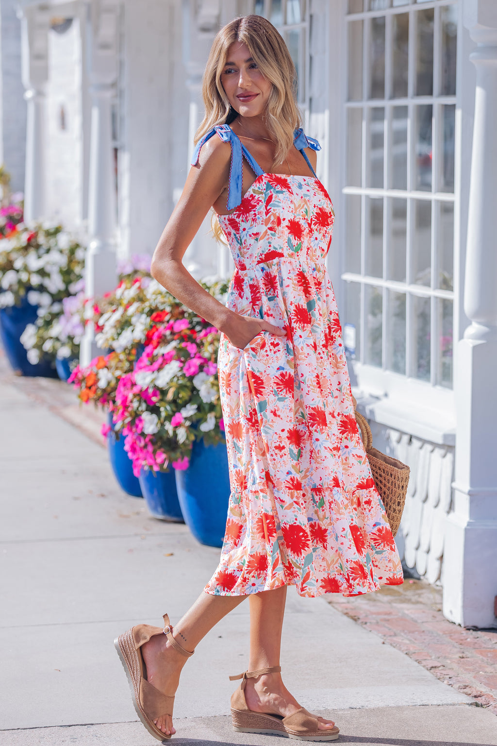 Red floral print denim strap high waist dress with contrast stitching and knot detail, suitable for casual or summer wear.