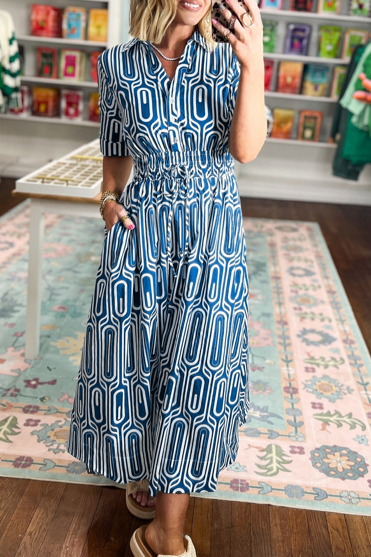 Blue geometric print maxi dress by Dear-Lover with short sleeves, drawstring waist, and shirt collar in cotton-viscose fabric.